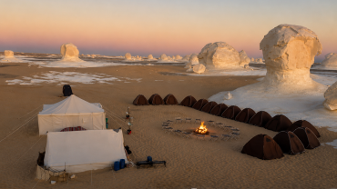 Desert camp under a pastel sky