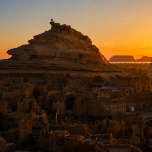 Desert village at sunset with mesas