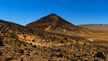 Desert volcanic landscape under clear sky