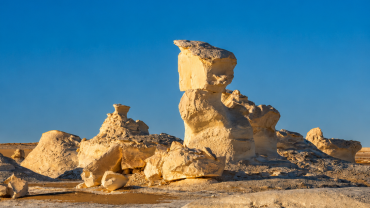 Eroded hoodoos under a golden sky