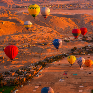 Golden hour over desert with balloons
