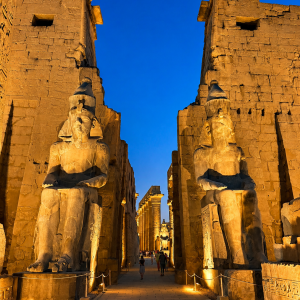 Grand temple entrance with seated pharaohs