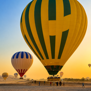 Hot air balloons at sunrise in desert