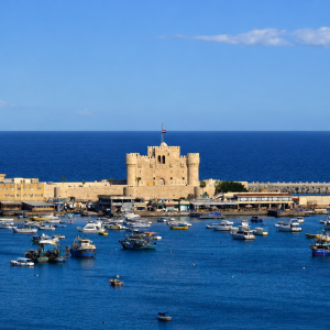 Mediterranean harbor with fortress and boats
