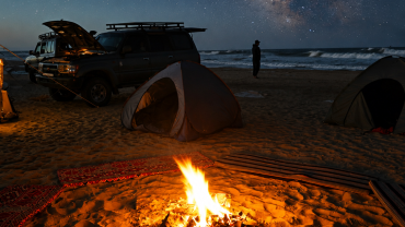 Starry night beach campsite glow