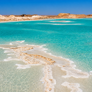 Vibrant turquoise lagoon in desert landscape