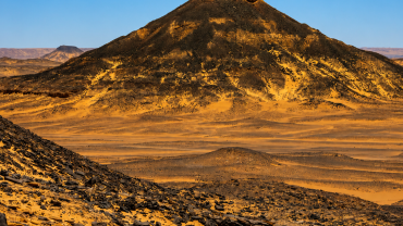 Volcanic hill in desert landscape