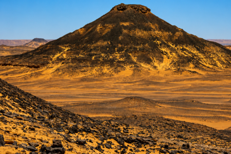 Volcanic hill in desert landscape